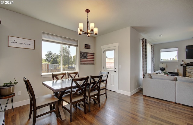 dining room featuring an inviting chandelier and dark wood-type flooring