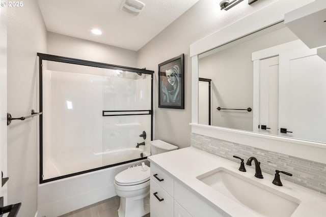 full bathroom with vanity, toilet, combined bath / shower with glass door, and backsplash