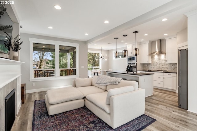 living room with a chandelier and light hardwood / wood-style flooring