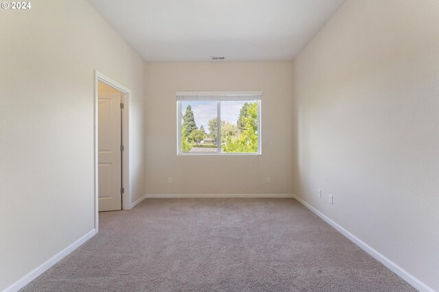 unfurnished room featuring carpet flooring