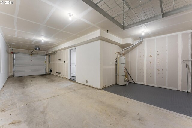 garage featuring strapped water heater and a garage door opener