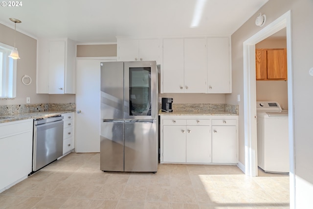 kitchen featuring light stone countertops, appliances with stainless steel finishes, decorative light fixtures, washer / dryer, and white cabinetry