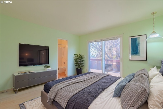 bedroom with access to exterior, connected bathroom, and light hardwood / wood-style floors