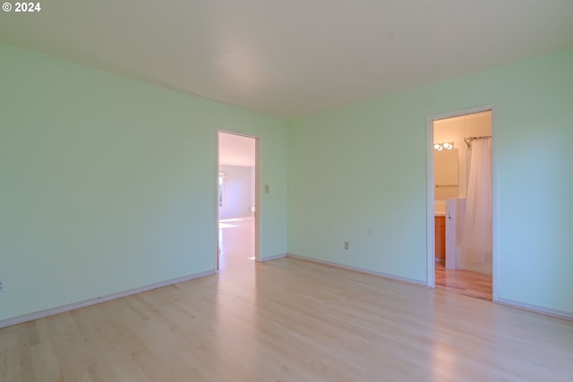 empty room with light hardwood / wood-style flooring