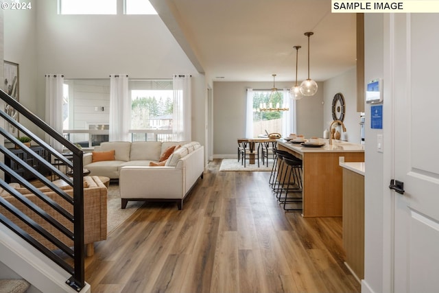 hallway featuring dark hardwood / wood-style flooring and a towering ceiling