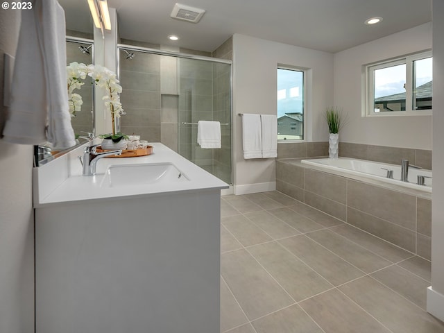 bathroom with tile patterned flooring, vanity, and independent shower and bath