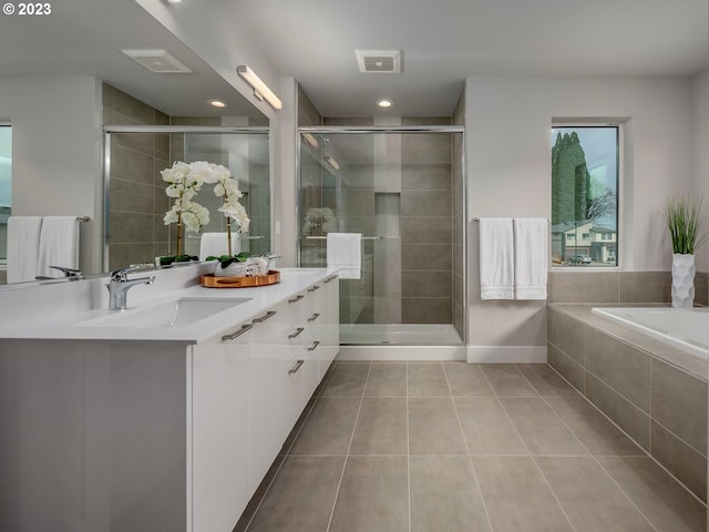 bathroom with separate shower and tub, tile patterned flooring, and vanity