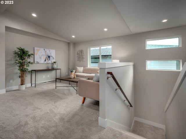 carpeted living room with lofted ceiling