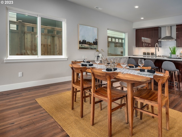 dining room with dark hardwood / wood-style flooring