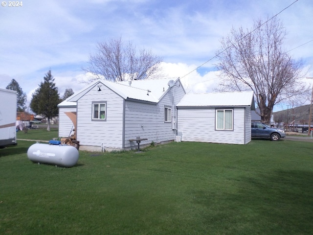 view of side of home with a yard