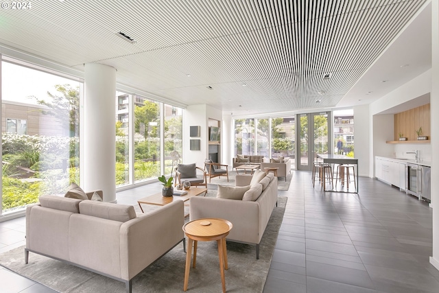 sunroom / solarium featuring wine cooler, indoor bar, and plenty of natural light