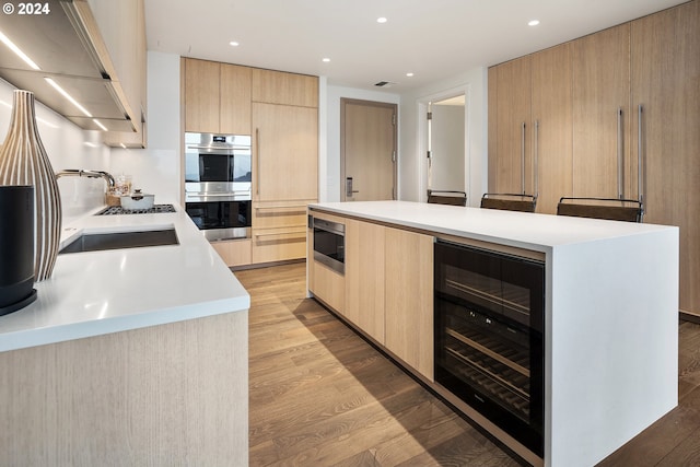 kitchen with stainless steel appliances, modern cabinets, beverage cooler, and light brown cabinetry