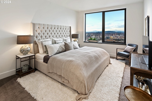 carpeted bedroom featuring baseboards