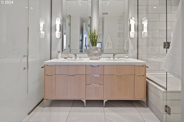 full bathroom featuring tile patterned flooring, double vanity, a shower with shower door, and a sink