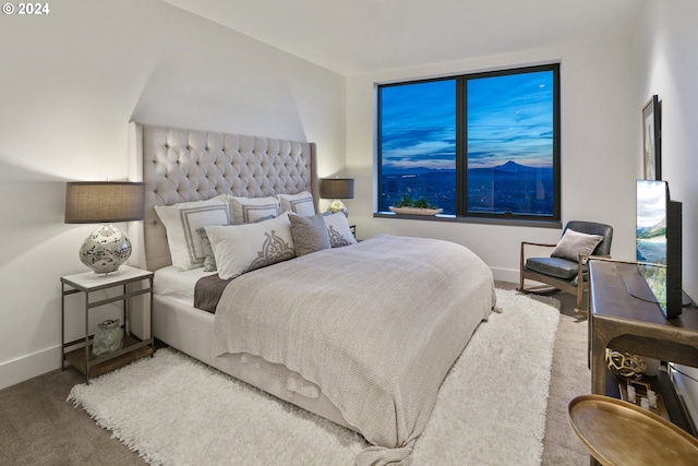 carpeted bedroom featuring baseboards