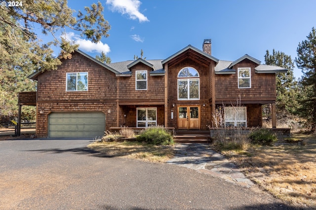 front facade featuring covered porch and a garage