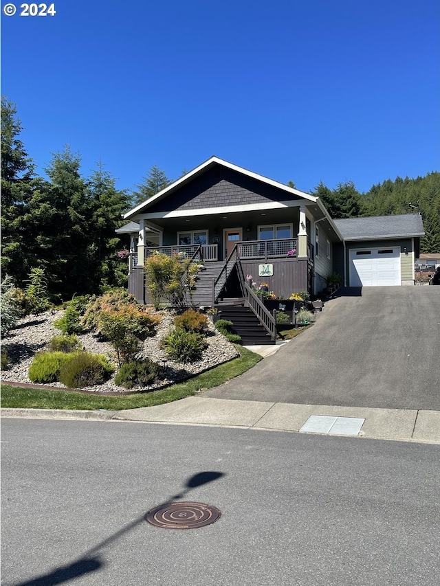 view of front of property with covered porch and a garage