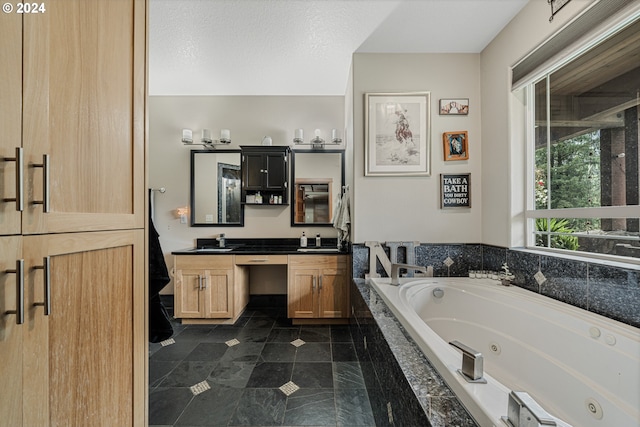 bathroom featuring tiled bath and vanity