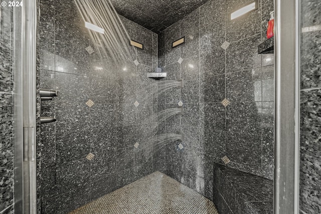 bathroom with a tile shower