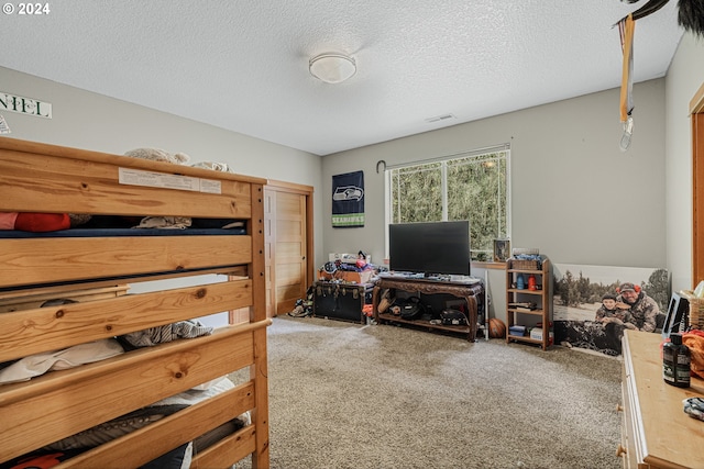 bedroom featuring a textured ceiling and carpet flooring