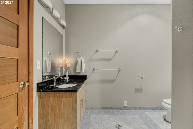 bathroom with vanity, toilet, and tile patterned flooring