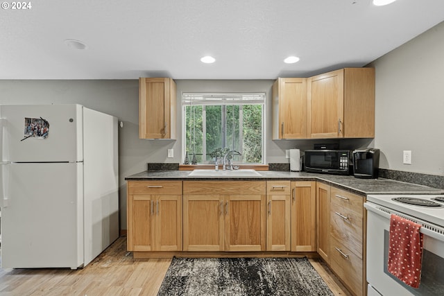 kitchen with white appliances, light hardwood / wood-style floors, a textured ceiling, and sink