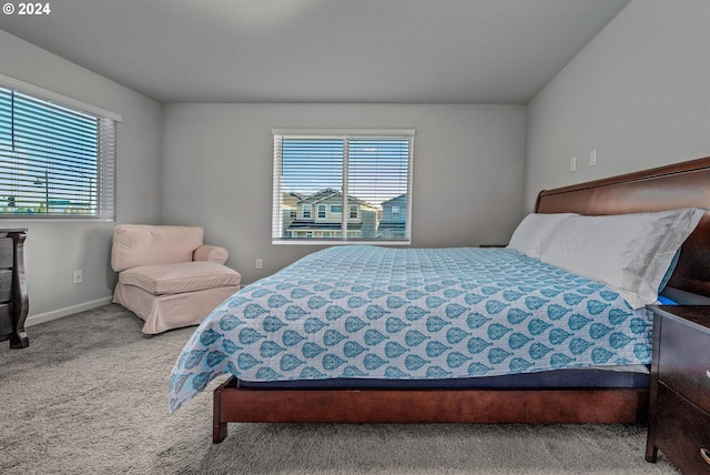 bedroom featuring carpet floors and baseboards