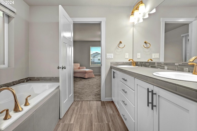 bathroom featuring a tub to relax in and vanity