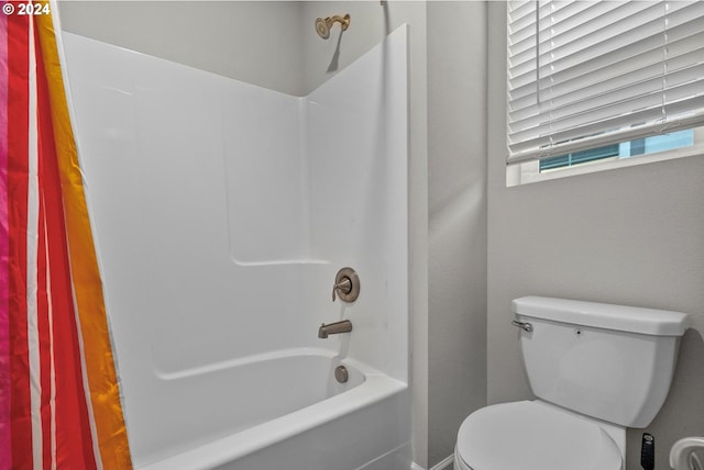 bathroom with toilet and bathtub / shower combination