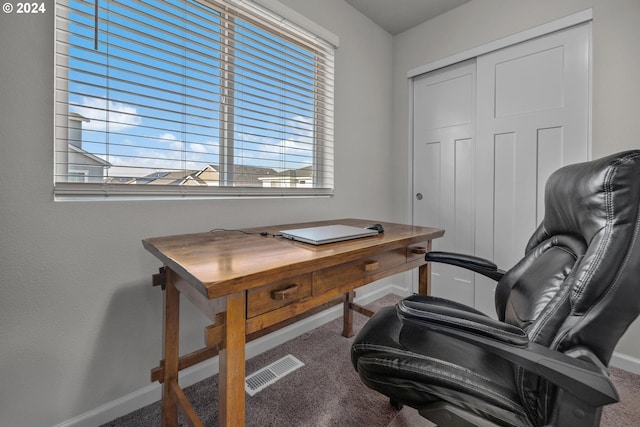 office space with carpet, visible vents, and baseboards