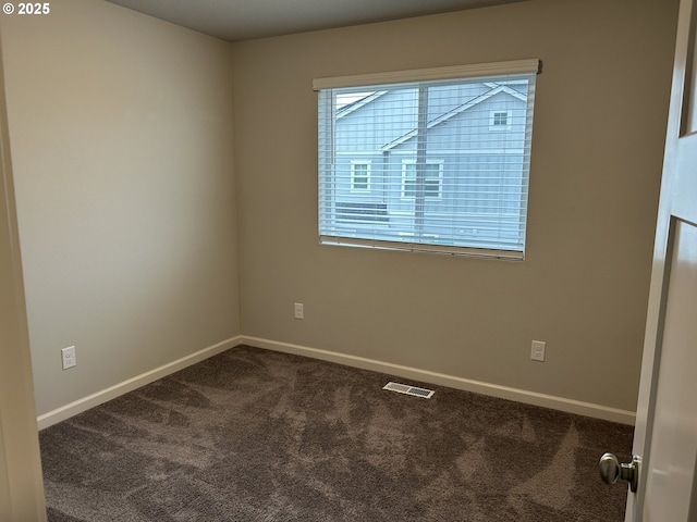 carpeted empty room featuring baseboards and visible vents