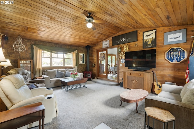 carpeted living room with wood ceiling, a wood stove, and wood walls