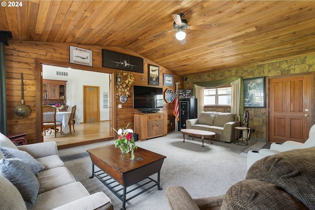 living room featuring vaulted ceiling, wood walls, wooden ceiling, and carpet flooring