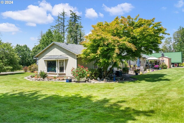 back of property featuring a yard and a patio