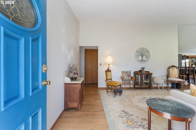 entryway with a textured ceiling and light hardwood / wood-style flooring