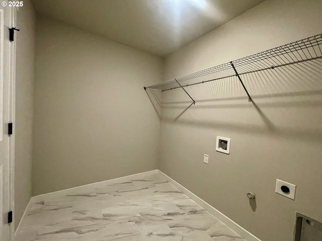 clothes washing area featuring laundry area, marble finish floor, baseboards, and washer hookup