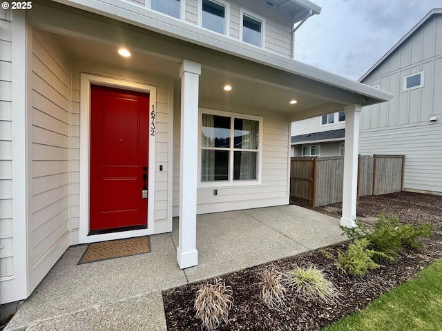 view of exterior entry with fence