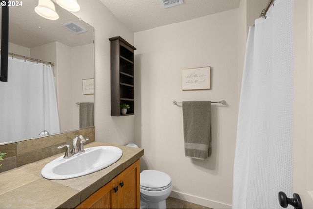 8844 NE Brentford Way, Hillsboro, OR 97006 - bathroom featuring vanity, toilet, a textured ceiling, and tasteful backsplash