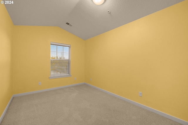 8844 NE Brentford Way, Hillsboro, OR 97006 - carpeted empty room featuring a textured ceiling and vaulted ceiling