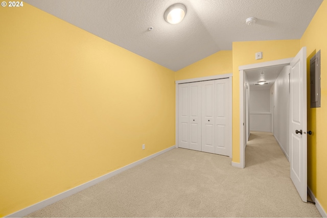 8844 NE Brentford Way, Hillsboro, OR 97006 - unfurnished bedroom with light carpet, a textured ceiling, electric panel, a closet, and lofted ceiling
