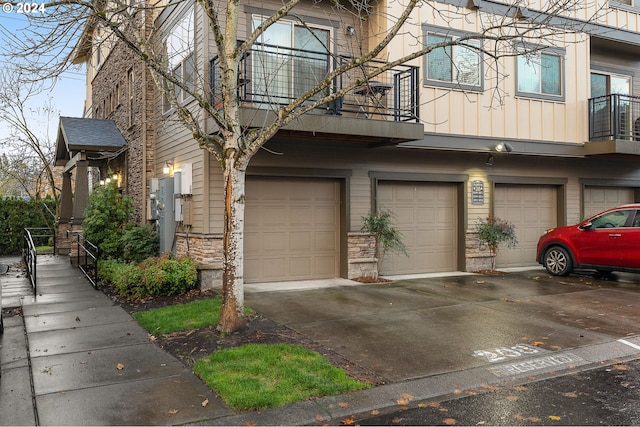 8844 NE Brentford Way, Hillsboro, OR 97006 - view of front facade featuring a balcony and a garage