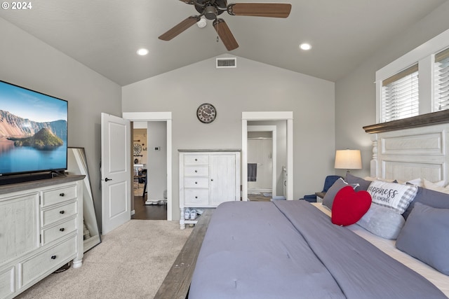 bedroom featuring lofted ceiling, connected bathroom, light colored carpet, and ceiling fan