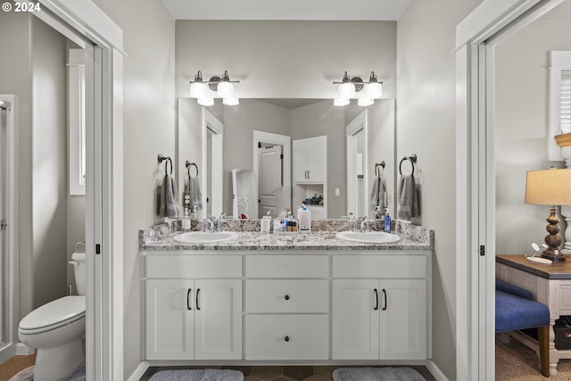 bathroom featuring vanity and toilet