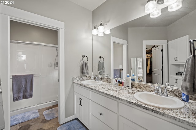 bathroom featuring walk in shower and vanity