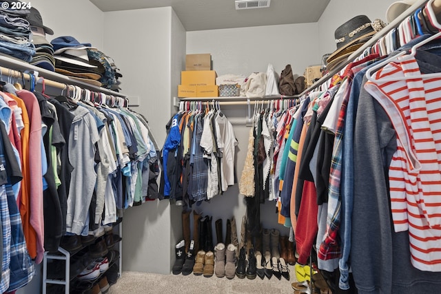 walk in closet with carpet flooring