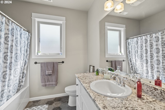 bathroom featuring vanity, a notable chandelier, and toilet