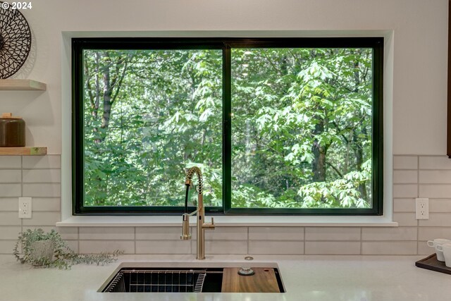 room details featuring decorative backsplash and sink