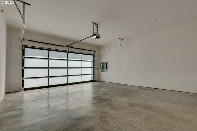 garage with electric panel and a garage door opener