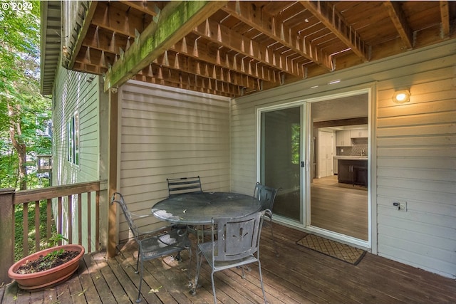 wooden deck featuring outdoor dining area