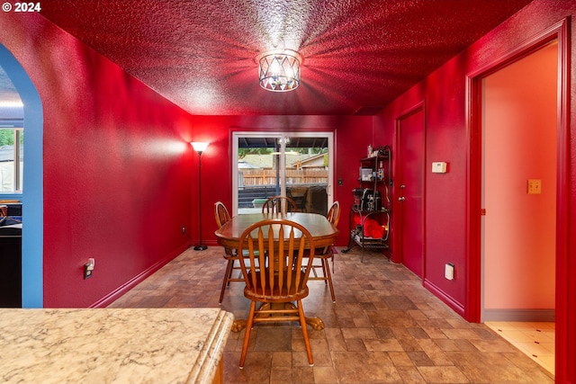 dining space with a textured ceiling